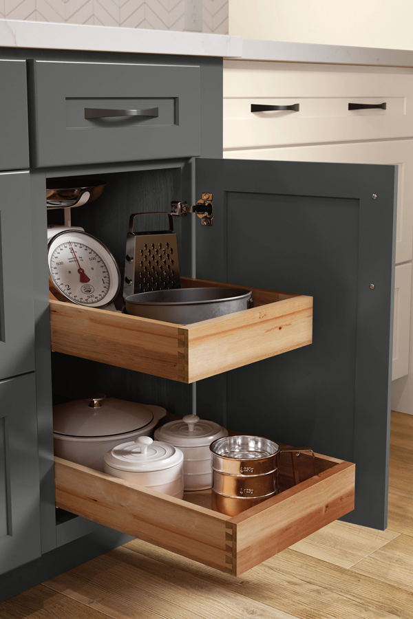 base cabinet roll tray opened and stocked with kitchen supplies